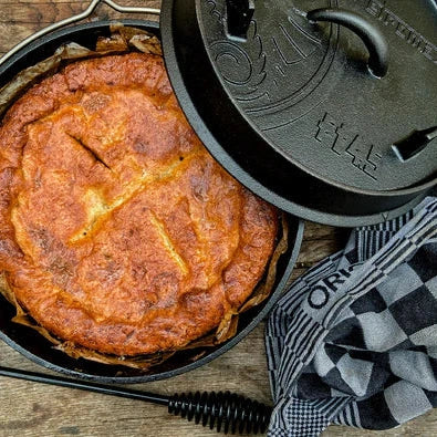 Cooked dish in Petromax cast iron Dutch oven, outdoor meal preparation