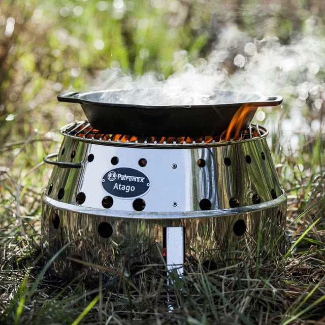 Cast iron skillet on portable camping stove outdoors