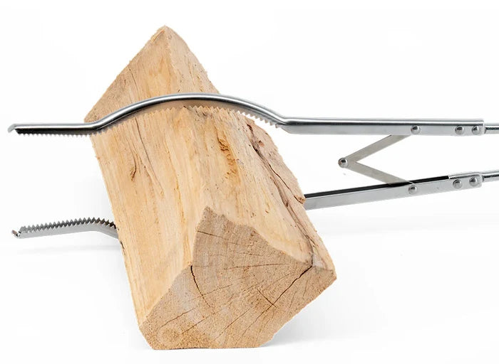 Set of outdoor grill accessories including a log clamp and spatula