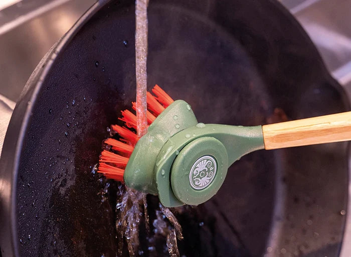 Petromax cast iron brush cleaning a pan