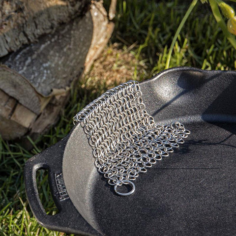Chain mail cleaner on cast iron pan for cleaning