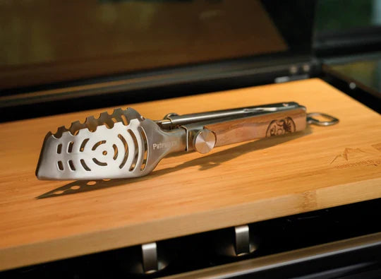 Petromax Telescopic Grill Tongs on wooden surface for outdoor cooking