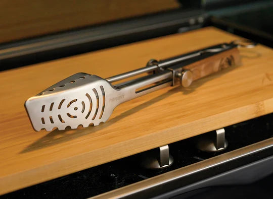 Petromax Telescopic Grill Tongs displayed on wooden countertop for grilling