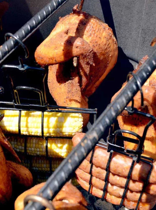 Pit Barrel 3-Hanger Value Pack - FireFly Barbecue in action with corn, sausage, and chicken hanging in cooker. Maximizes cooking space for full meals.