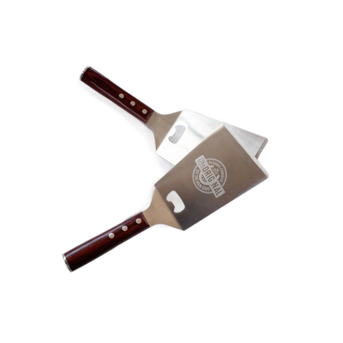 Pit Barrel Spatula used for flipping burgers on grill with logo visible
