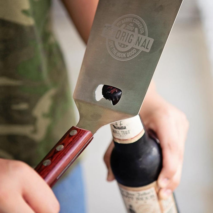 Close-up of Pit Barrel Spatula with logo on stainless steel blade for outdoor grill accessories
