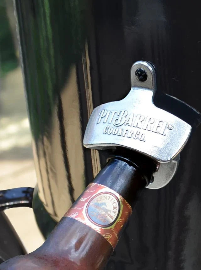 Mounted Pit Barrel bottle opener on outdoor grill with bottle