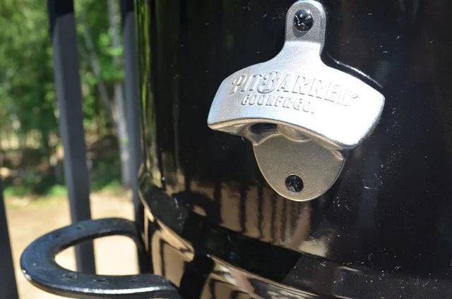 Pit Barrel bottle opener attached to black grill