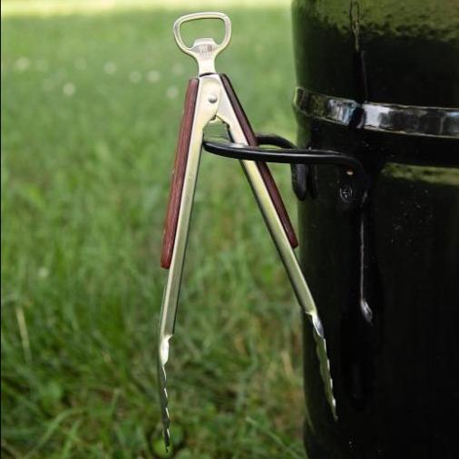 Outdoor grill tongs hanging on grill