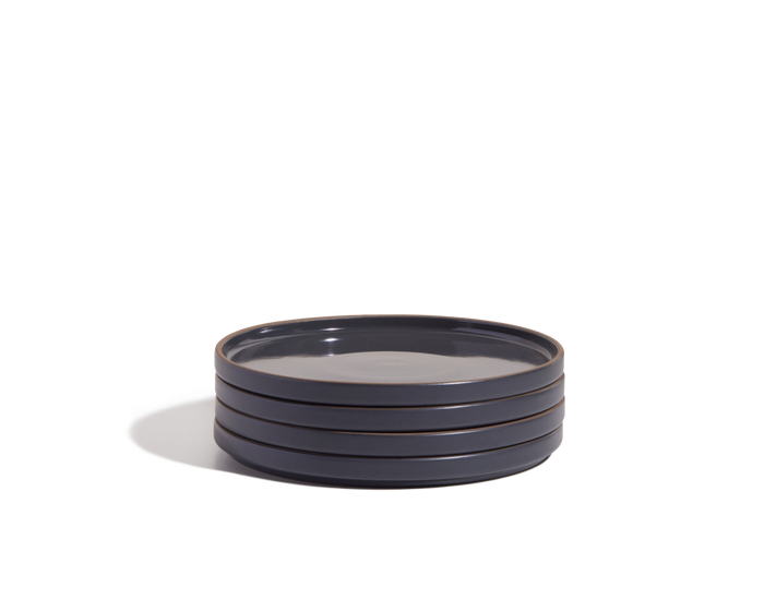 A stack of four dark blue hand-glazed Salad Plates is displayed against a white background.