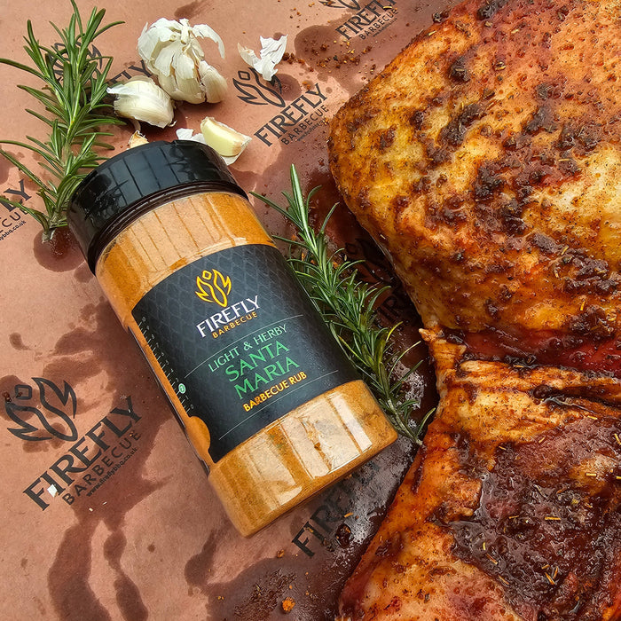 Santa Maria Seasoning Rub - Spice Blend for Meats | 200g next to seasoned meat and rosemary, showcasing BBQ preparation.