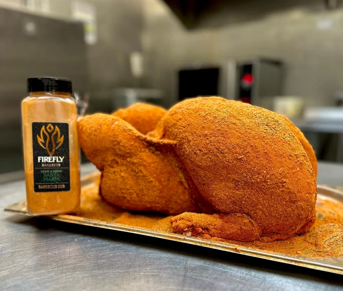 Whole chicken coated with Santa Maria Seasoning Rub - Spice Blend for Meats | 200g, ready for roasting or grilling.