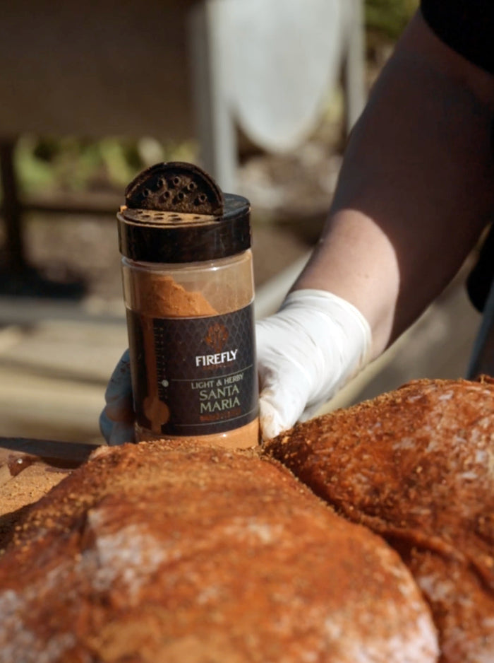 Santa Maria Seasoning Rub - Spice Blend for Meats | 200g being applied to meat outdoors, ideal for BBQ enthusiasts.