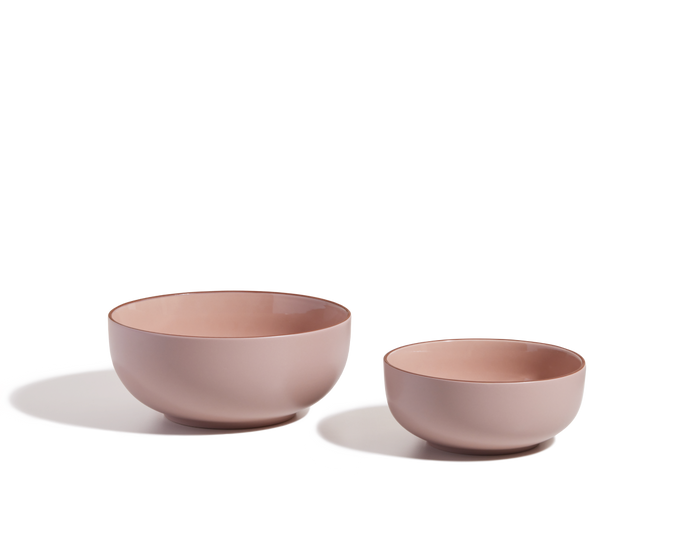 Two Serving Bowls of different sizes in pink ceramic are displayed side by side on a white background, creating a charming tableware set.