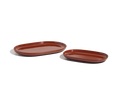 Two reddish-brown ceramic Serving Platters in oval shapes and different sizes are displayed on a white background, ideal for adding elegance to your tableware set.