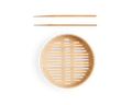The Spruce Steamer, a round bamboo steamer basket with a slatted base, is placed below bamboo cooking chopsticks against a white background.