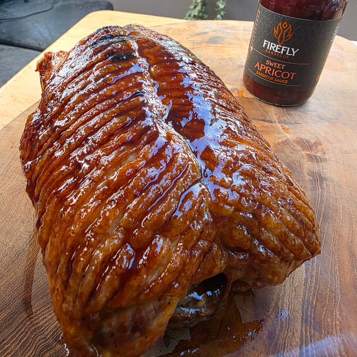 BBQ sauce bottle with grilled meat and vegetables