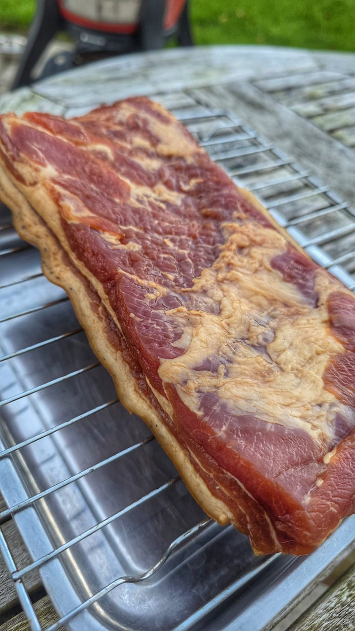 Bacon strips on grill for outdoor barbecue cooking