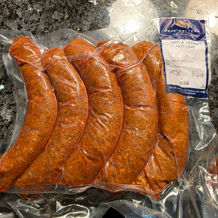 Raw sausages on grill
