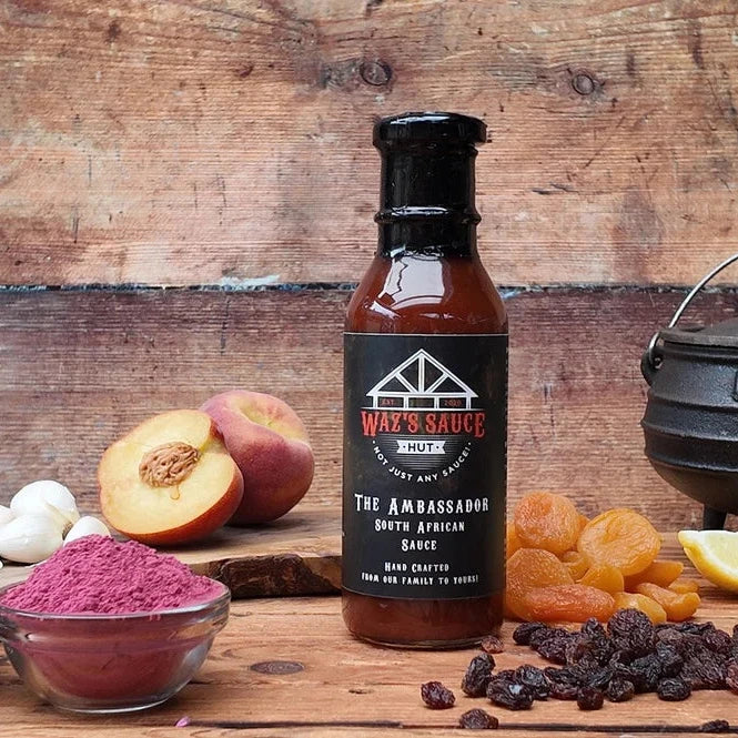 Waz's Sauce bottle on wooden background with fruits and spices