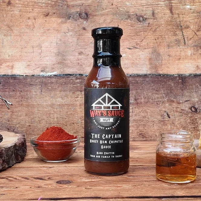 Waz's Sauce Honey Rum Chipotle BBQ with spices and condiments
