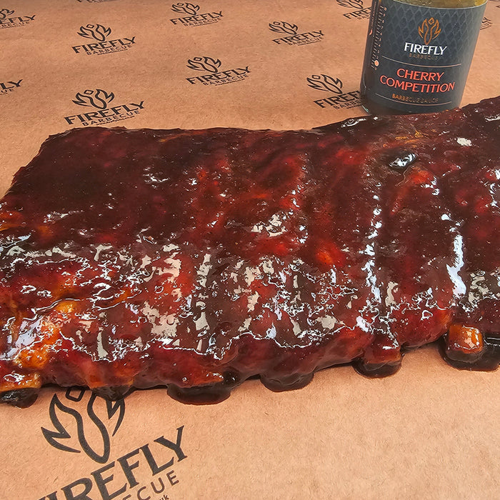 Raw pork spareribs on Firefly BBQ branded paper